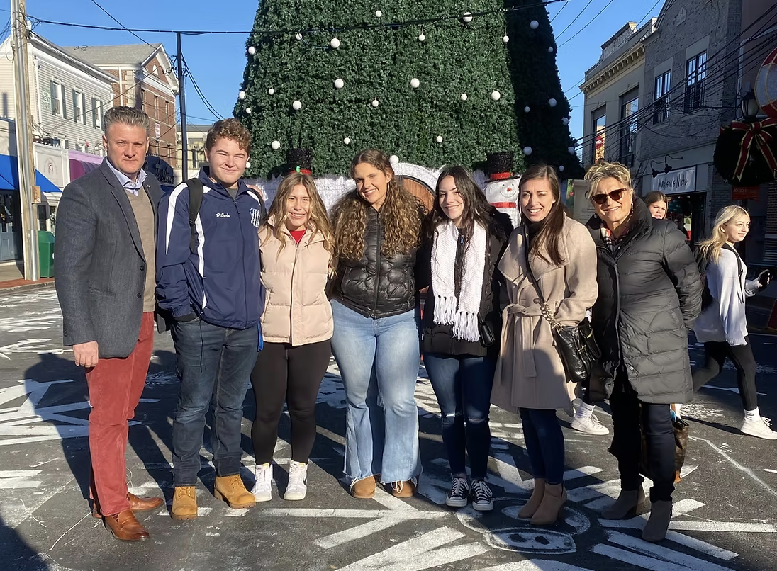 Students gather with soon-to-be retiree Ms. Maniscalchi (far right) during a Christmas celebration.